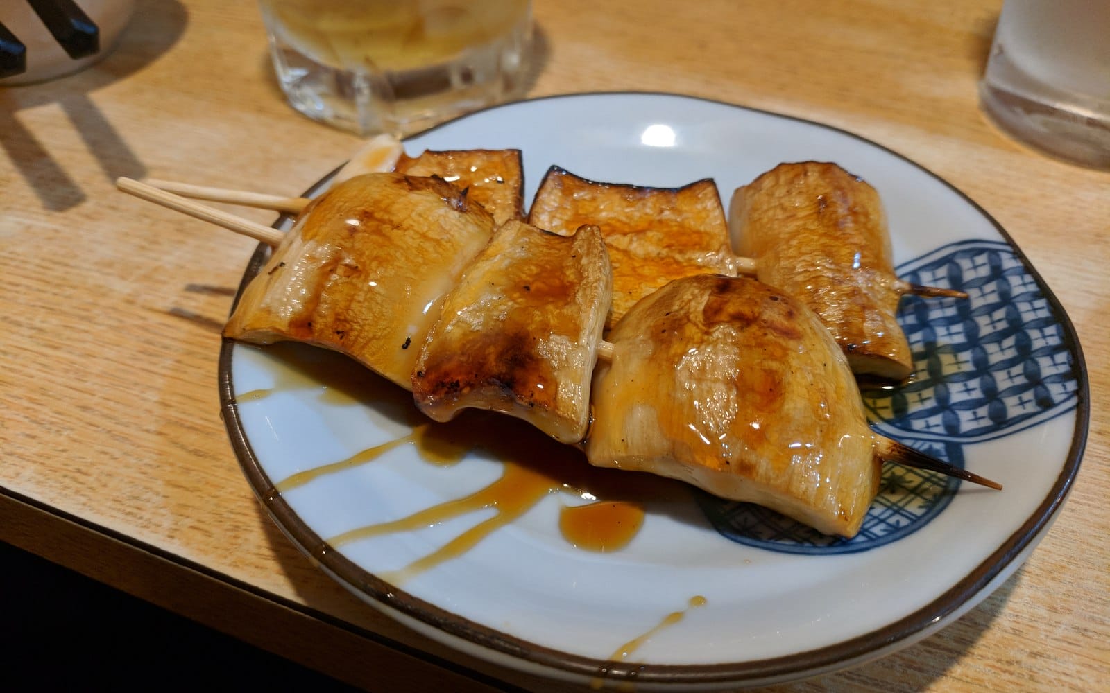 Glazed grilled mushroom pieces served on wooden skewers